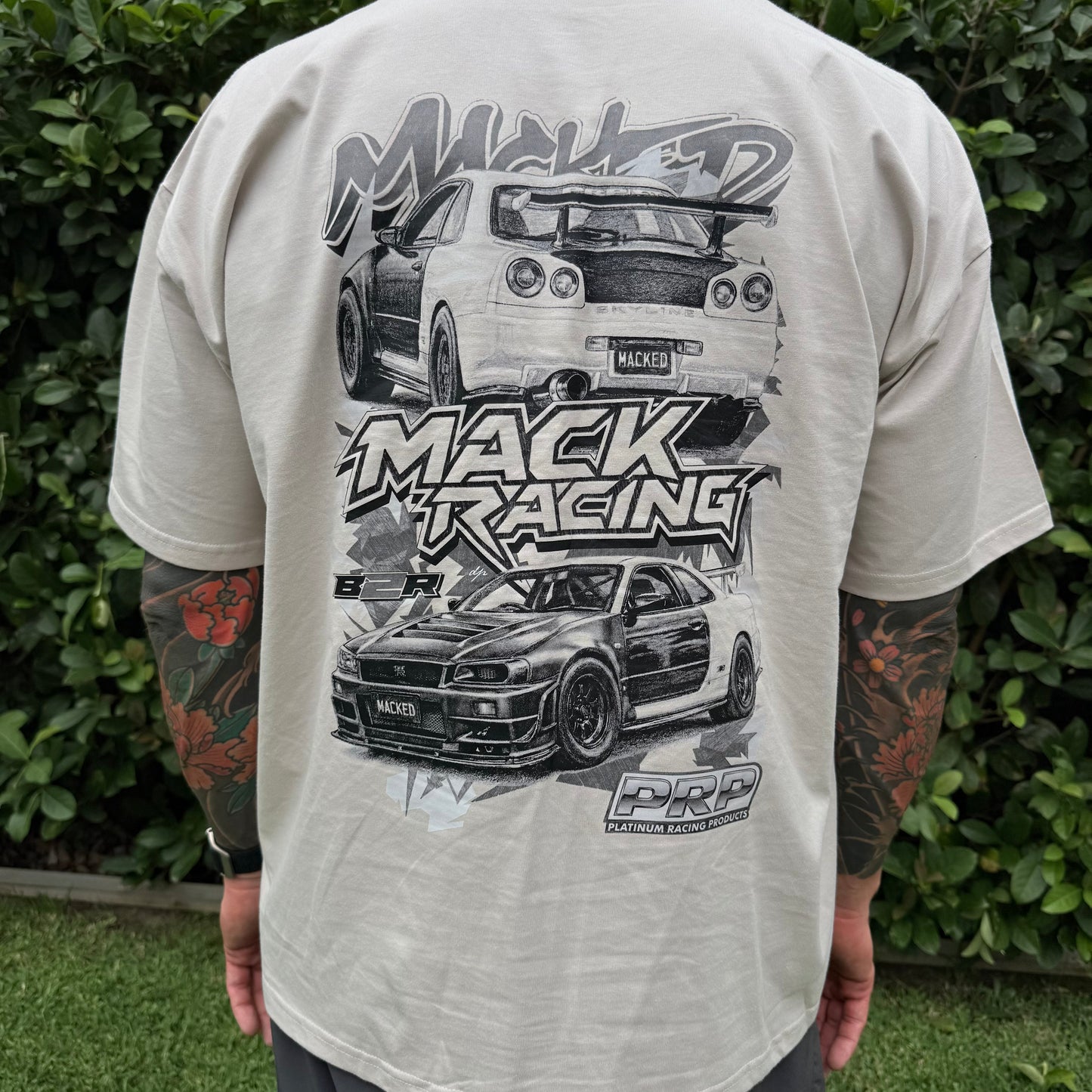 Person wearing a t-shirt with car graphics and 'Mack Racing' text.