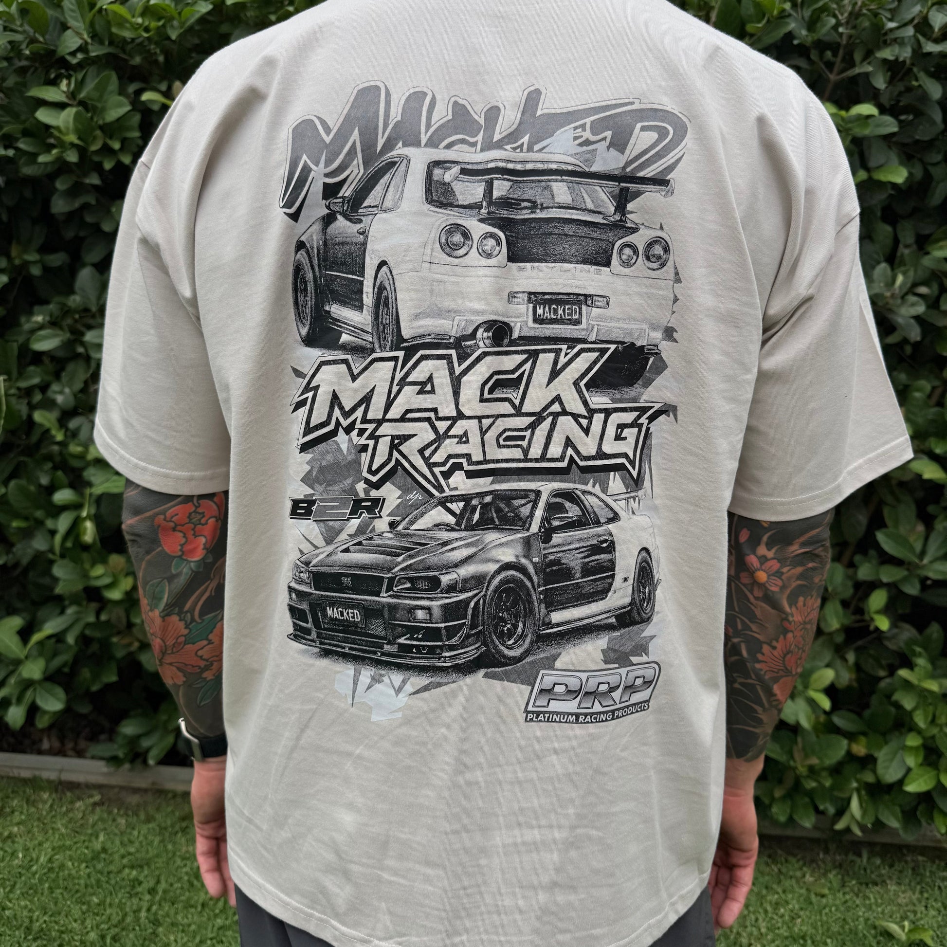 Person wearing a t-shirt with car graphics and 'Mack Racing' text.
